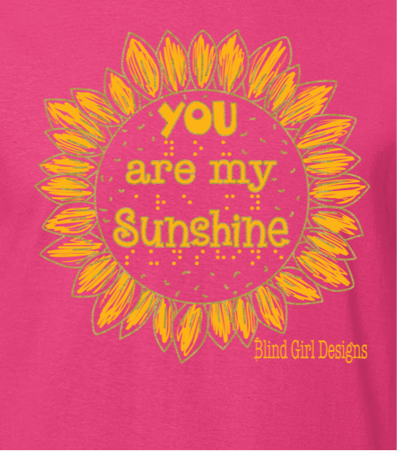 The center of the classically shaped sunflower says “you are my sunshine” in both quirky 3-D letters and braille.
Each of the hand drawn petals of the sunflower are surrounded by an outline of metallic gold. 