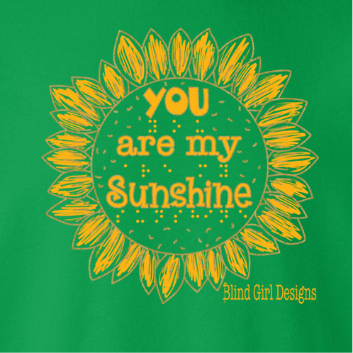 The center of the classically shaped sunflower says “you are my sunshine” in both quirky 3-D letters and braille.
Each of the hand drawn petals of the sunflower are surrounded by an outline of metallic gold. 