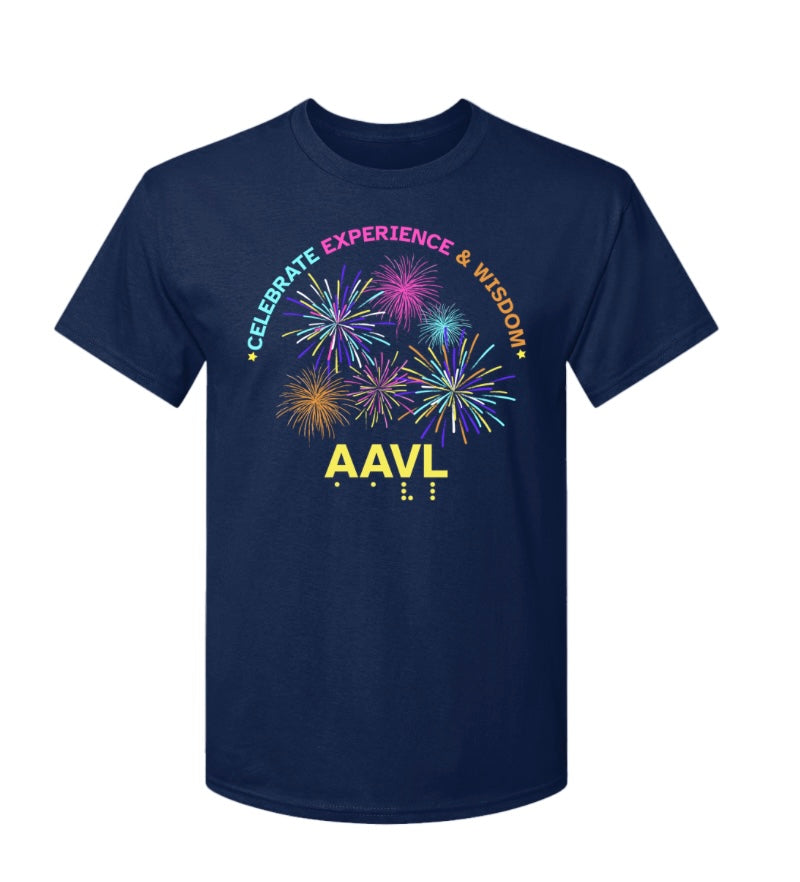 This navy blue t-shirt The top of the print has the words CELEBRATE in teal, EXPERIENCE in pink, AND WISDOM in orange. The words are in a graceful arch. Beneath the words in the center of the print is a dynamic colorful fireworks display.  At the bottom of the print in 3D yellow puff ink are the letters AAVL and below that are the letters in tactile, readable braille.