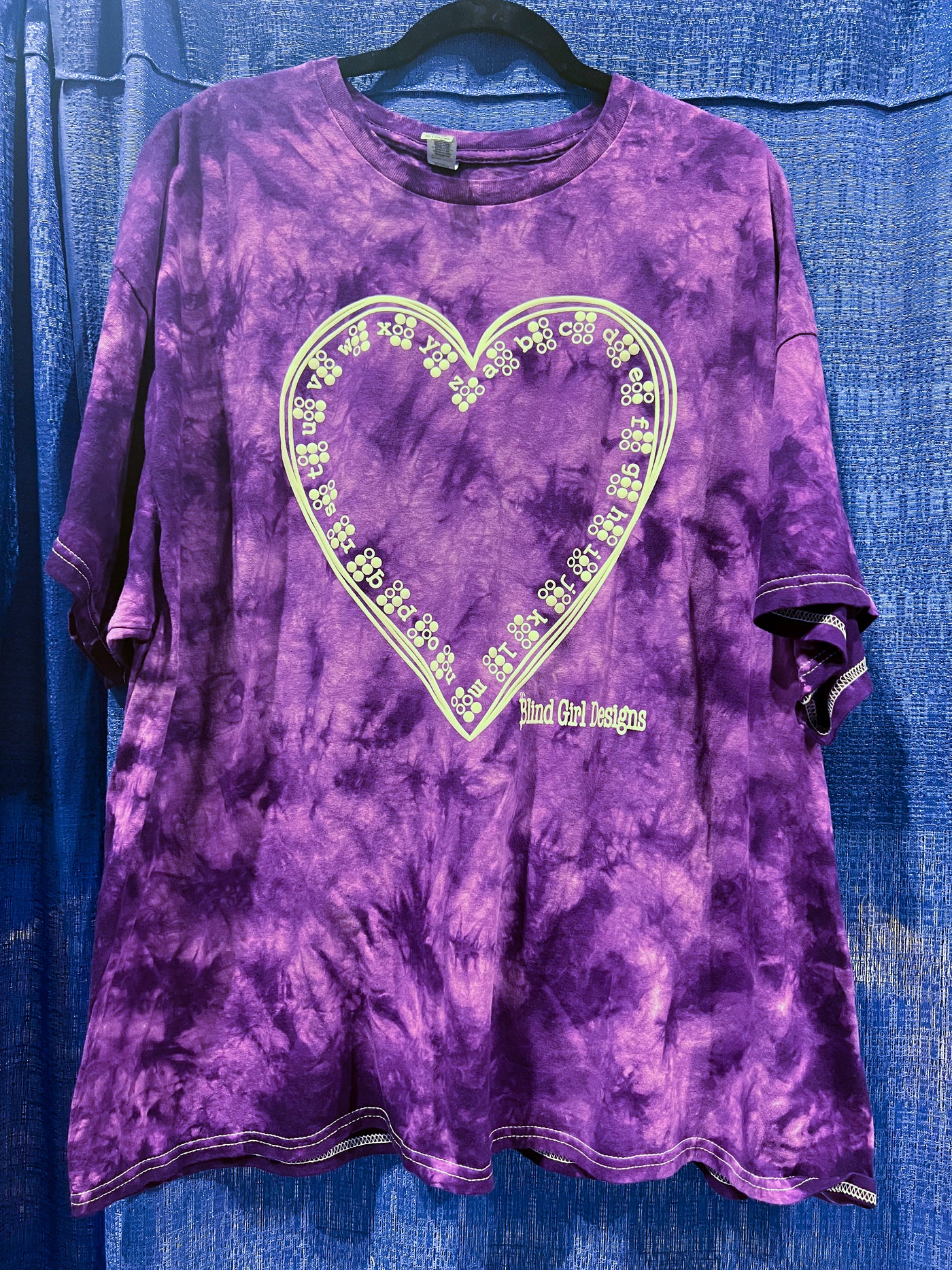 This dark and light purple tie-dye shirt features the Braille ABCs lining the inside of a hand-drawn heart. It has both the letters and the letters in Braille, which forms a beautiful pattern! It's printed in our puff ink so that it is tactile!