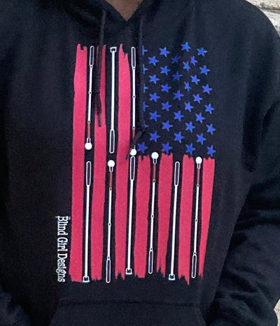 Cyndi is wearing a medium black hoodie, she is 5 foot 7 inches and medium is her normal size. It is a cool impression of the American flag. There are 50 blue stars, and red stripes that taper at the edges. The white stripes are made from a variety of white cane styles.