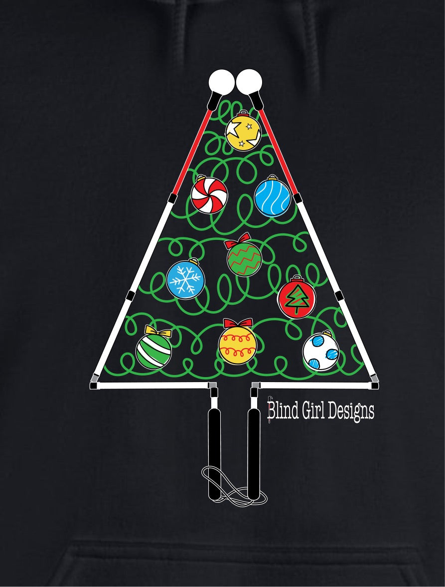 On a black t-shirt, there is a large colorful chest print of a whimsical Christmas tree outlined by two blind canes, folded at the joints to make a triangle tree shape on the front of this green t-shirt. The handles form the trunk and the roller balls form the outline of the top of the tree. The inside of the tree has green squiggles to suggest light strands with red, yellow, white, and blue ornaments shaped like a roller ball on the bottom of a cane.